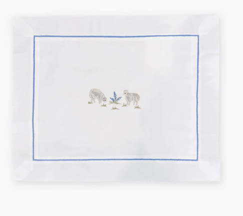 White lumbar pillowcase with embroidered design of two sheep and a blue border on a white background