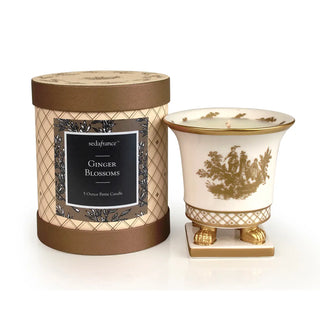 The Petite Ceramic, a footed porcelain vessel that is not only crafted in the shape of a classic French vase, it can be used to hold your favorite bouquets for years beyond the life of the candle. Each container is hand-painted with gold toile accents. This little 5 ounce creation comes in an elegant, cylindrical box.