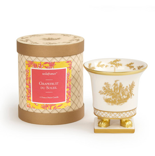 The Petite Ceramic, a footed porcelain vessel that is not only crafted in the shape of a classic French vase, it can be used to hold your favorite bouquets for years beyond the life of the candle. Each container is hand-painted with gold toile accents. This little 5 ounce creation comes in an elegant, cylindrical box.