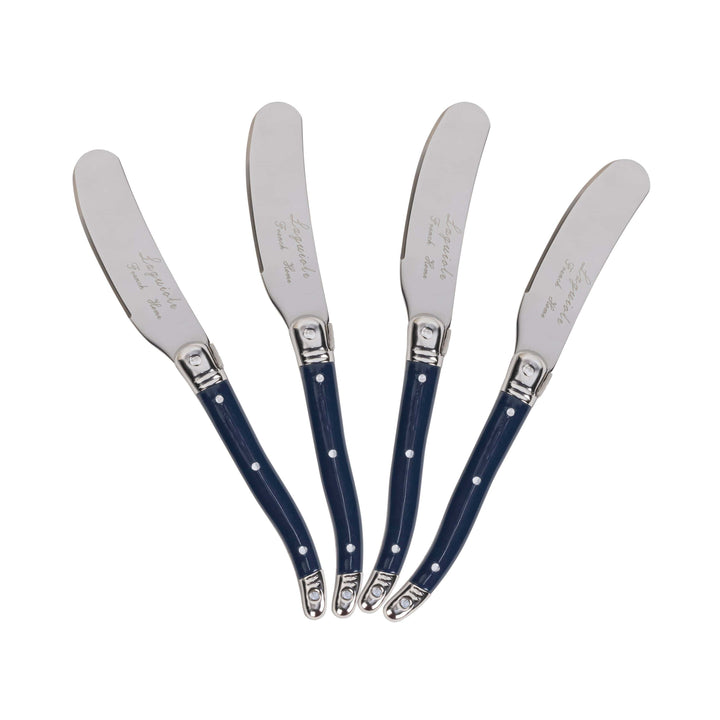 Four silver metal spreader knives with dark blue handles, arranged in a fan shape on a plain white background. Each handle features small white polka dots and a silver metal tip.