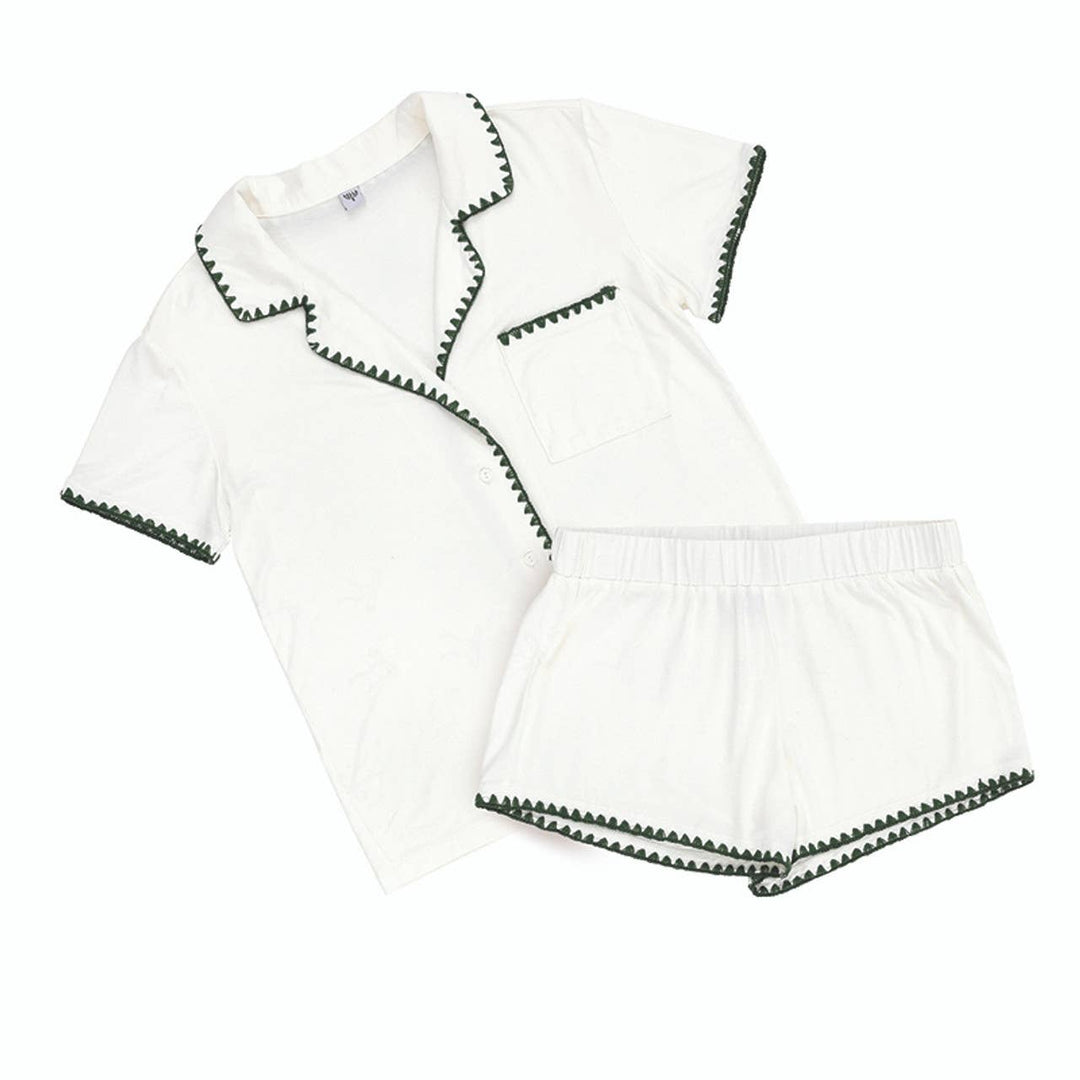 White outfit with dark green trim on a white background