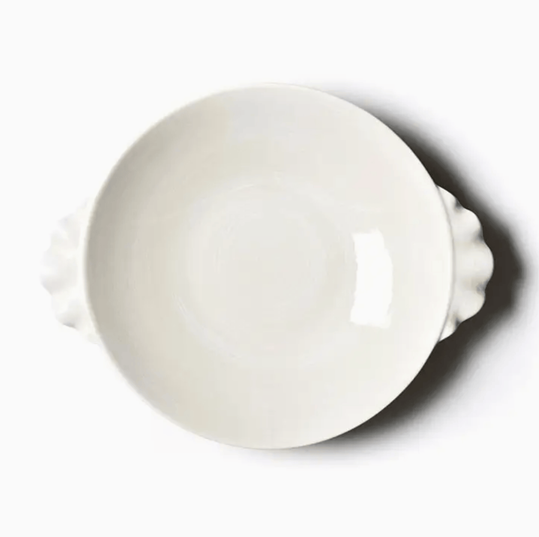 round pasta bowl with ruffle handles on a white background