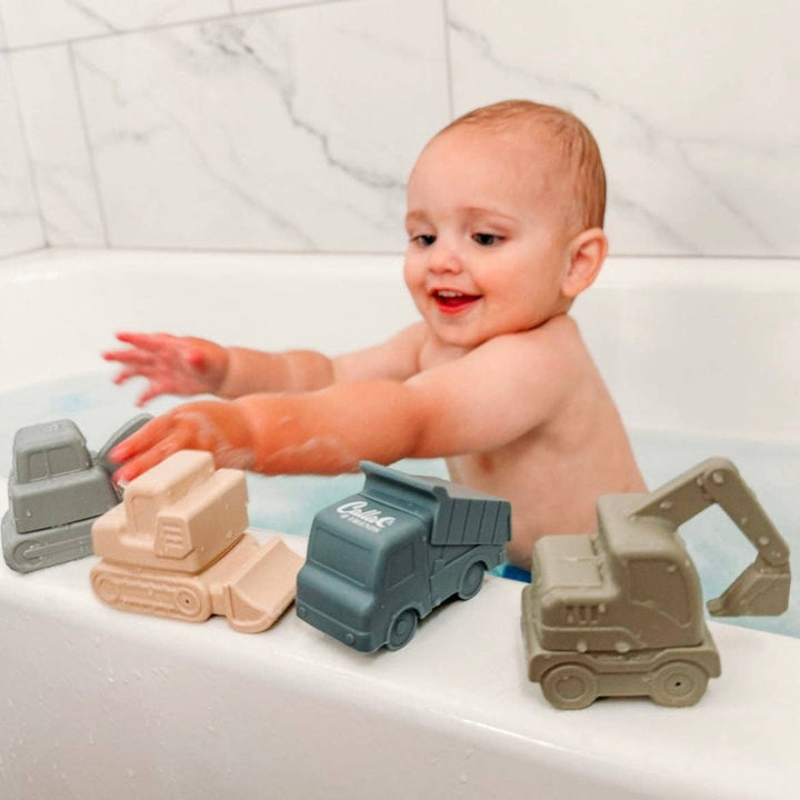 Baby playing with bath toys in a bathtub