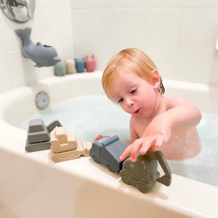 Child playing with bath toys in a bathtub