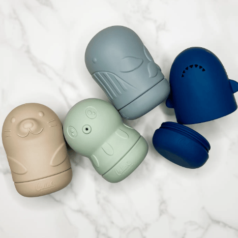 Five silicone snack containers in different colors on a white background