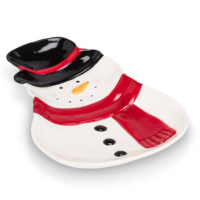 A ceramic snowman-shaped serving dish with a glossy white body, black hat, red scarf, and orange carrot nose, photographed on a clean white background.
