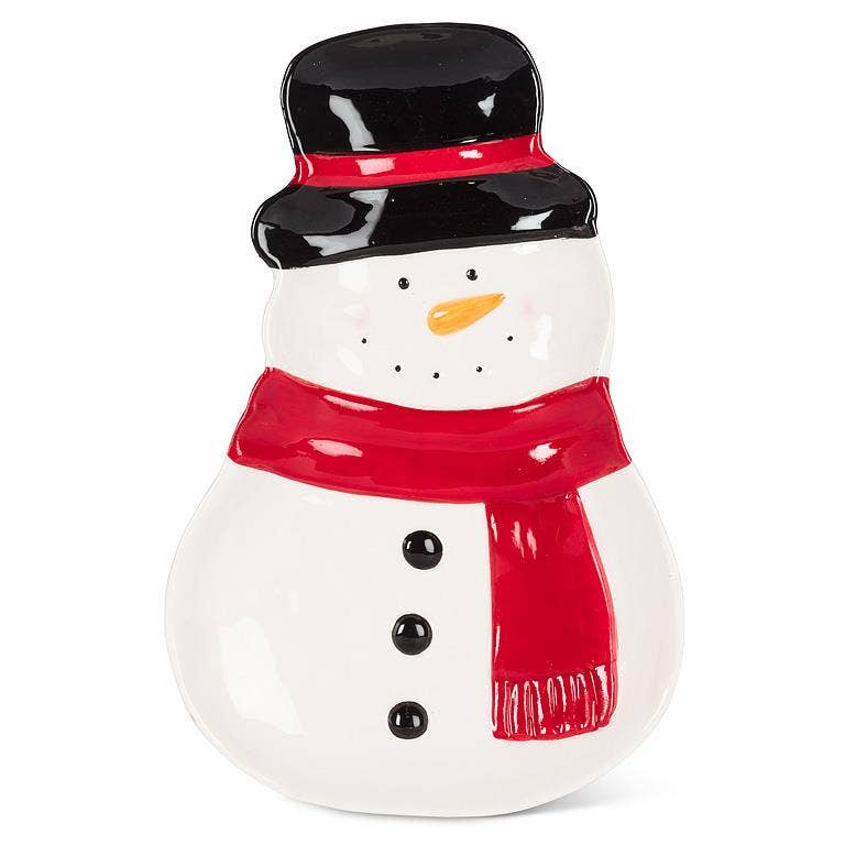 A ceramic snowman figurine with a glossy white body, a black top hat with a red band, a bright red scarf, and a small orange carrot nose, shown on a plain white background.