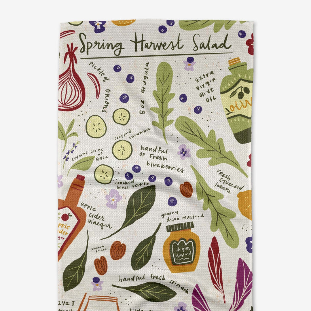 Patterned towel with spring harvest salad design on a white background