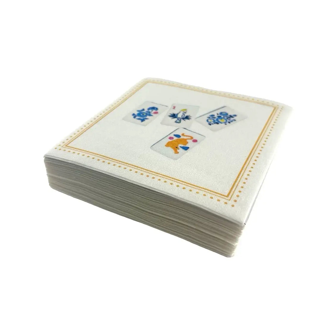 Stack of linen feel cocktail napkins with decorative mahjong designs on a white background