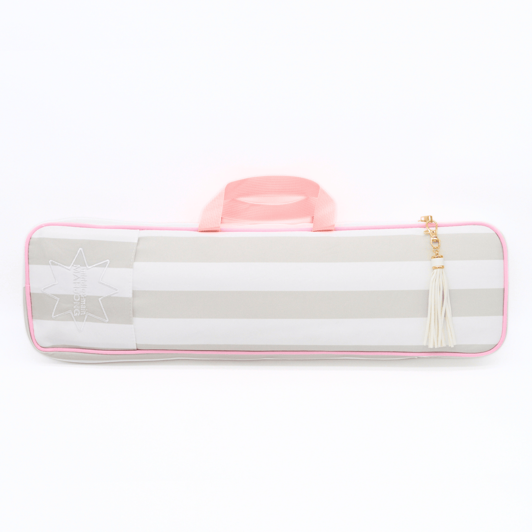A horizontal soft-sided mahjong rack bag with alternating light gray and white stripes, a pink handle, a pink piping border, a white embroidered star design on the left, and a cream tassel zipper pull with a gold-tone ring, shown on a plain white background.