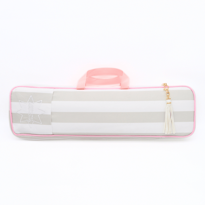 A horizontal soft-sided mahjong rack bag with alternating light gray and white stripes, a pink handle, a pink piping border, a white embroidered star design on the left, and a cream tassel zipper pull with a gold-tone ring, shown on a plain white background.