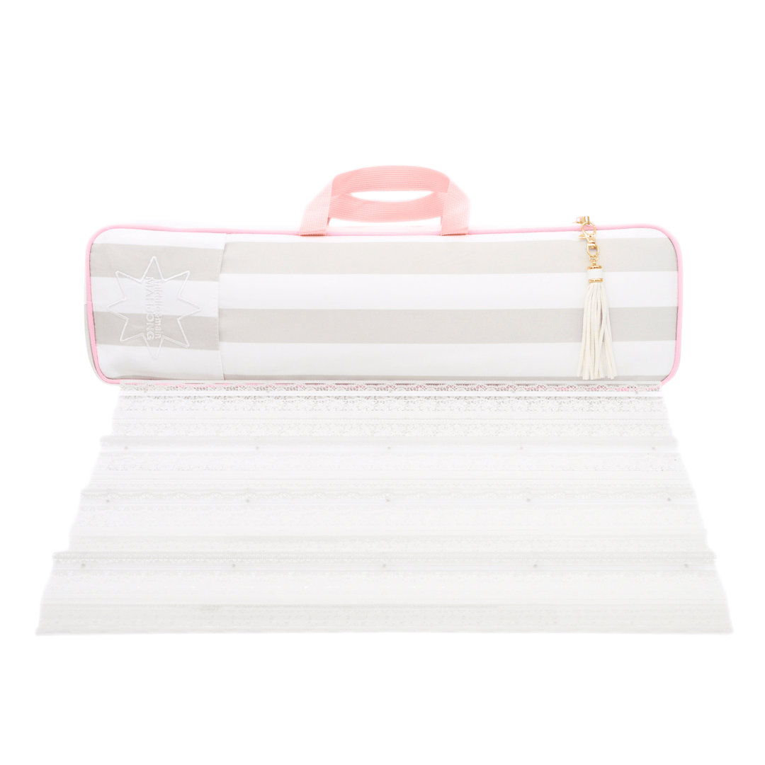 white and beige striped mahjong rack bag with a pink handle and tassel zipper pull, shown above its unfolded white textured surface on a white background.