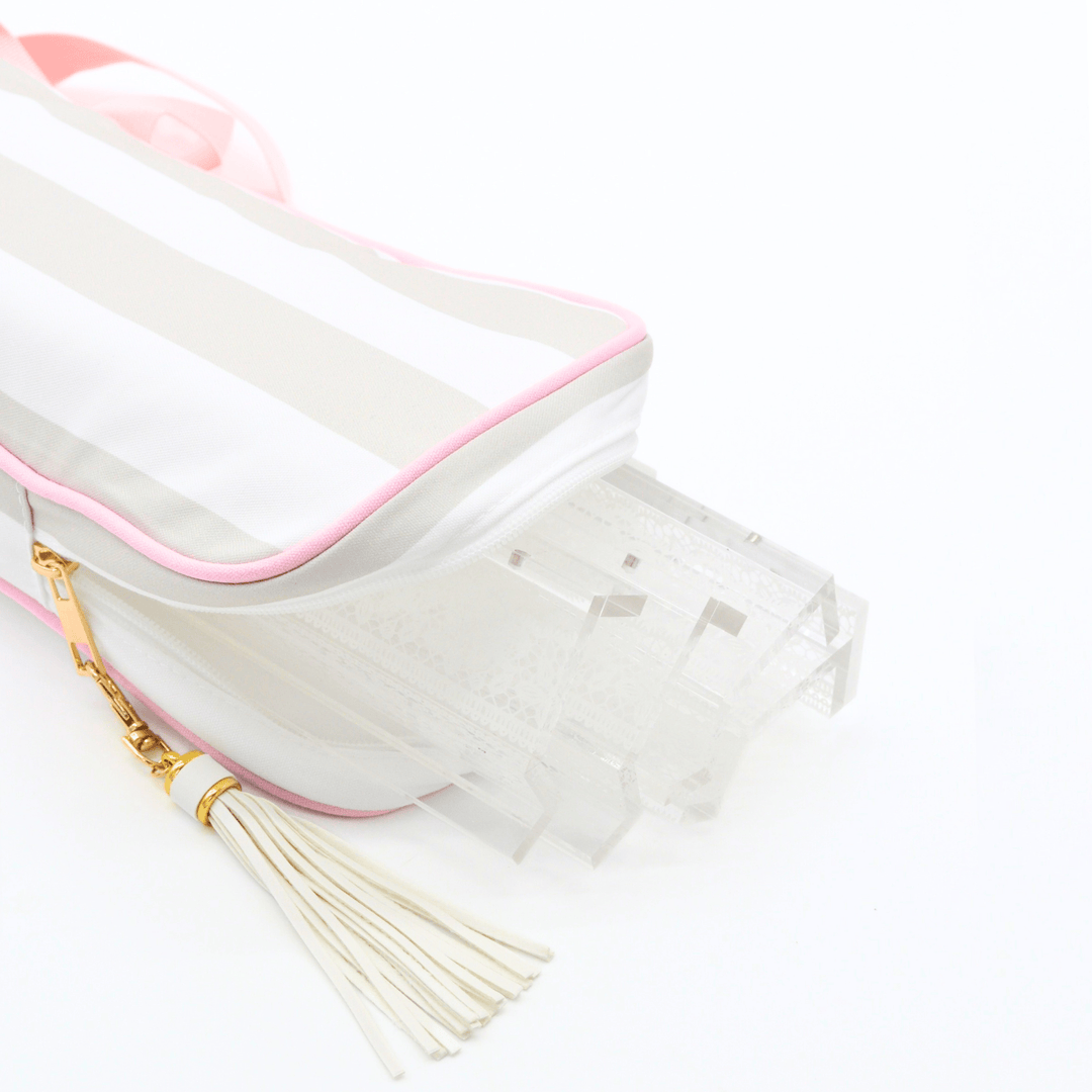 
gray and white striped mahjong rack bag with clear racks, featuring a cream tassel with a gold ring and a gold zipper pull, shown on a white background.p