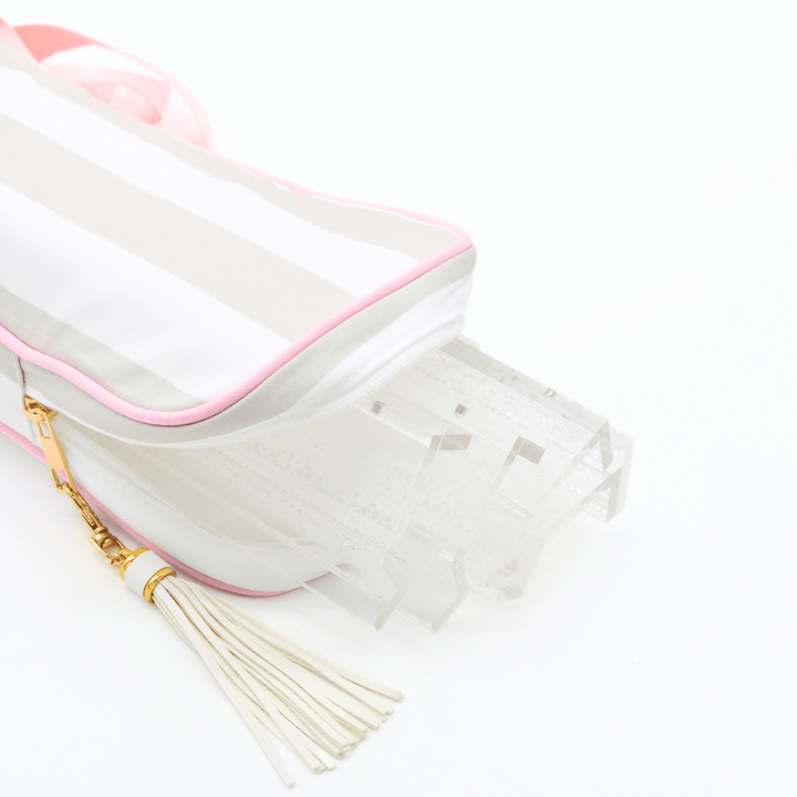 
gray and white striped mahjong rack bag with clear racks, featuring a cream tassel with a gold ring and a gold zipper pull, shown on a white background.p