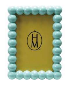Turquoise beaded picture frame with 'HM' logo on a yellow background