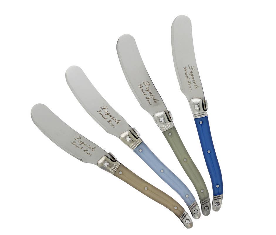 Set of four cheese spreaders with different shades of blue or cream handles on a white background