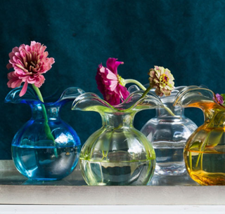 Skilled Tuscan artisans reimagine the beauty and delicate nature of the hibiscus flower in our mouthblown Hibiscus Glass. Curving, romantic, and fresh, the collection exudes easy elegance. The Hibiscus Glass Clear Bud Vase brings crisp beauty to even the simplest floral arrangement.  Product Dimensions: 5"D, 5.5"H, 12 oz