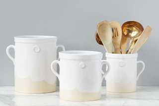 With a clay seal on each side and sturdy handles, the handthrown crock is the ideal utensil holder next to your stove or as a flower vase on your counter.