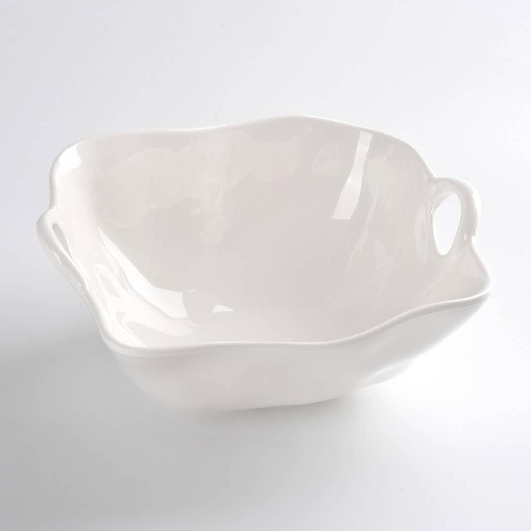 White ceramic bowl with handles on a light gray background