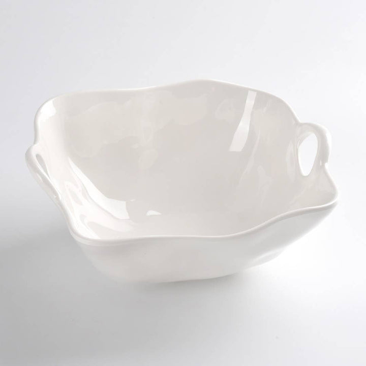 White ceramic bowl with handles on a light gray background