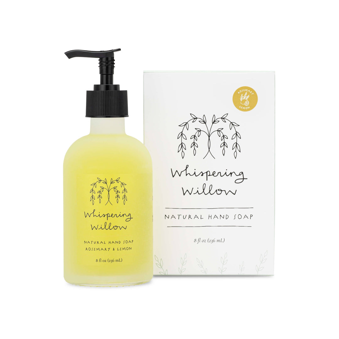 Frosted glass bottle of 'Whispering Willow' natural hand soap with packaging on a white background