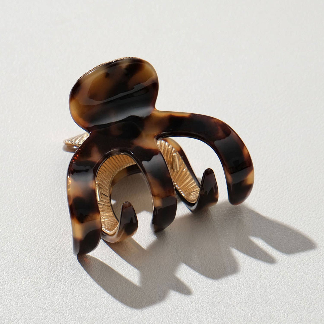 Tortoiseshell hair clip on a light gray background