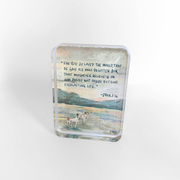 Glass block with a scenic design and text on a white background