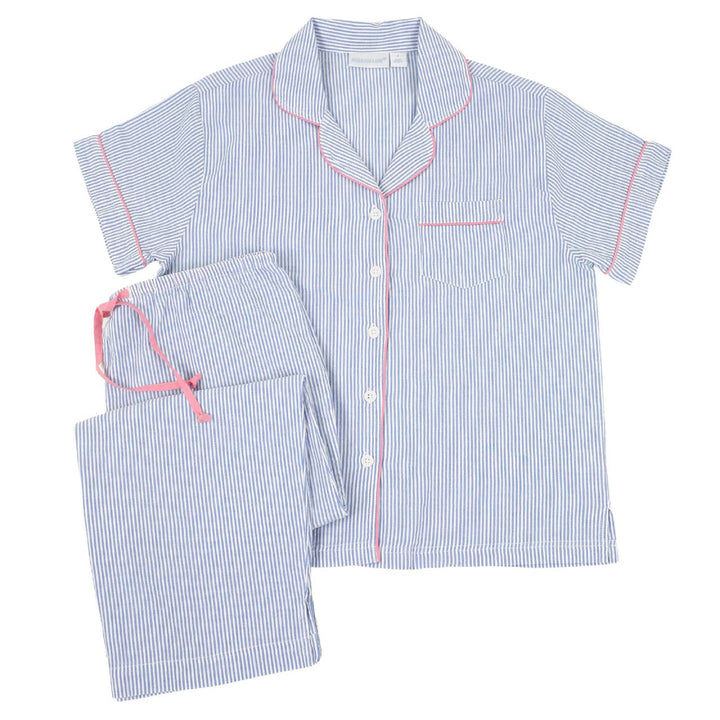 Blue and white striped pajama set with pink piping on a white background