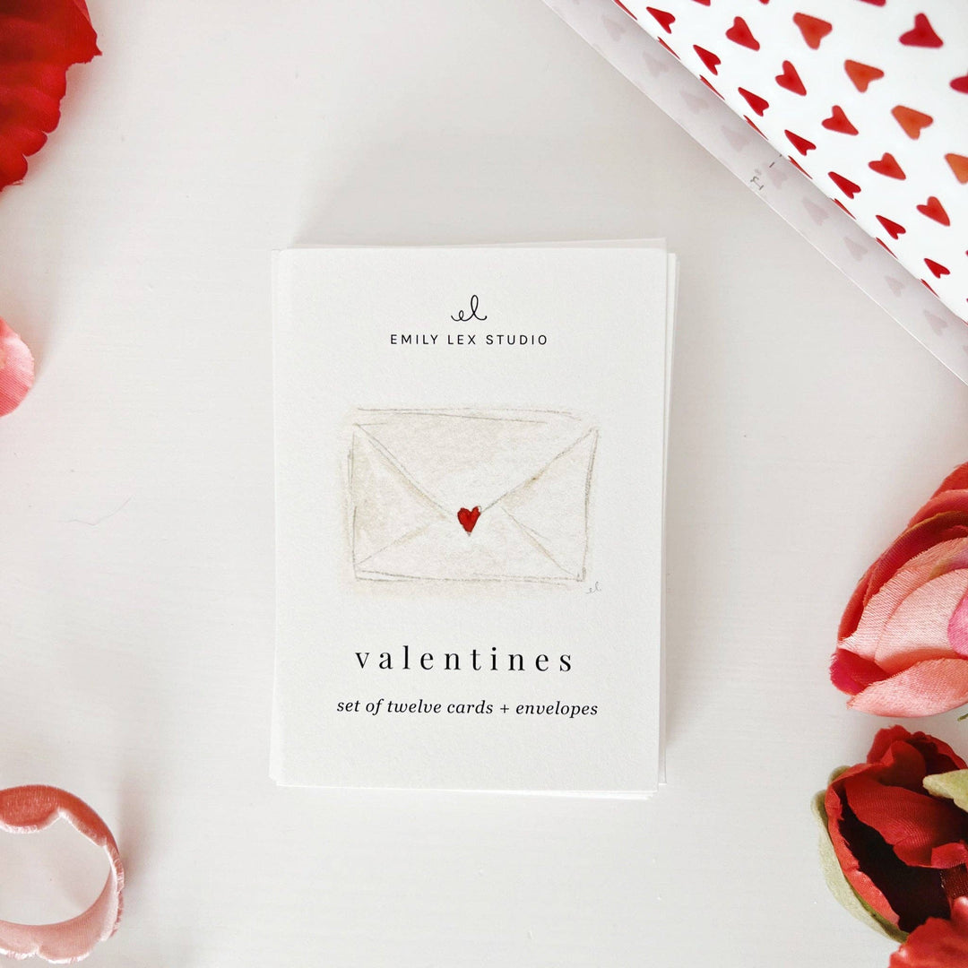 Set of twelve Valentine's cards and envelopes from Emily Lex Studio on a white background with decorative elements.