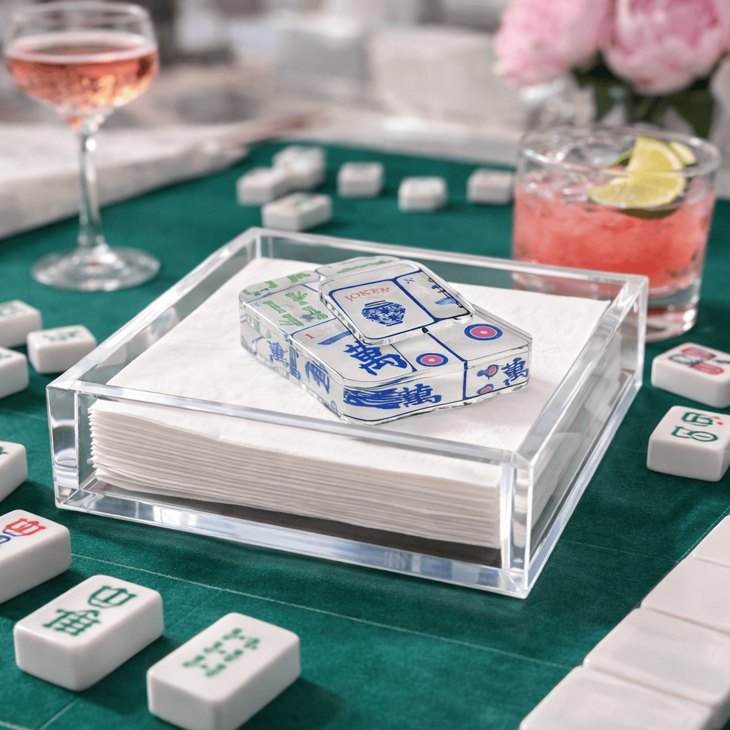 Clear acrylic napkin holder with white cocktail napkins and mahjong tile napkin weight. 