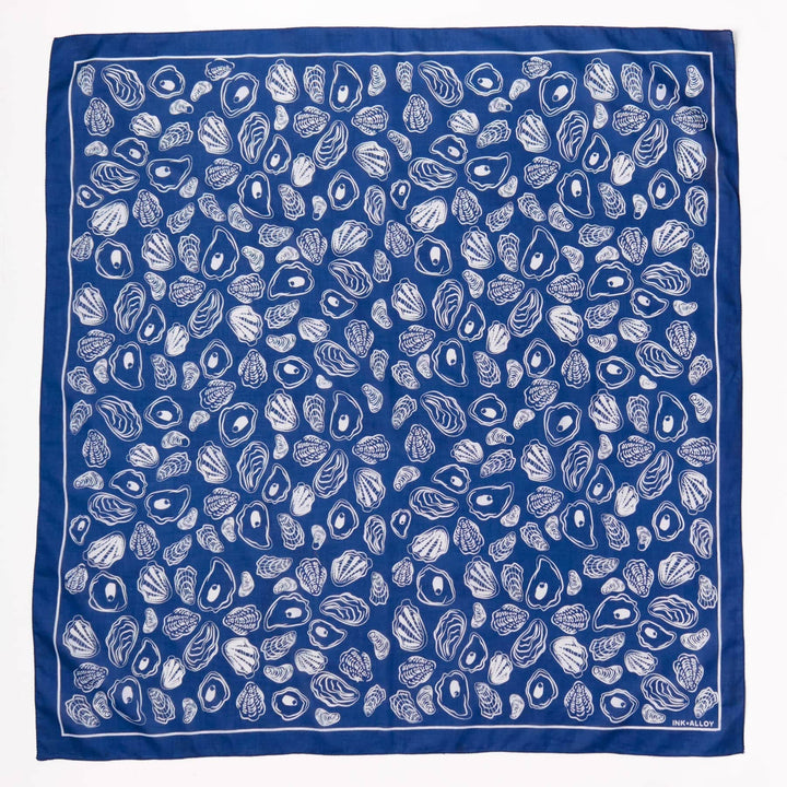 Blue scarf with white shell pattern on a white background