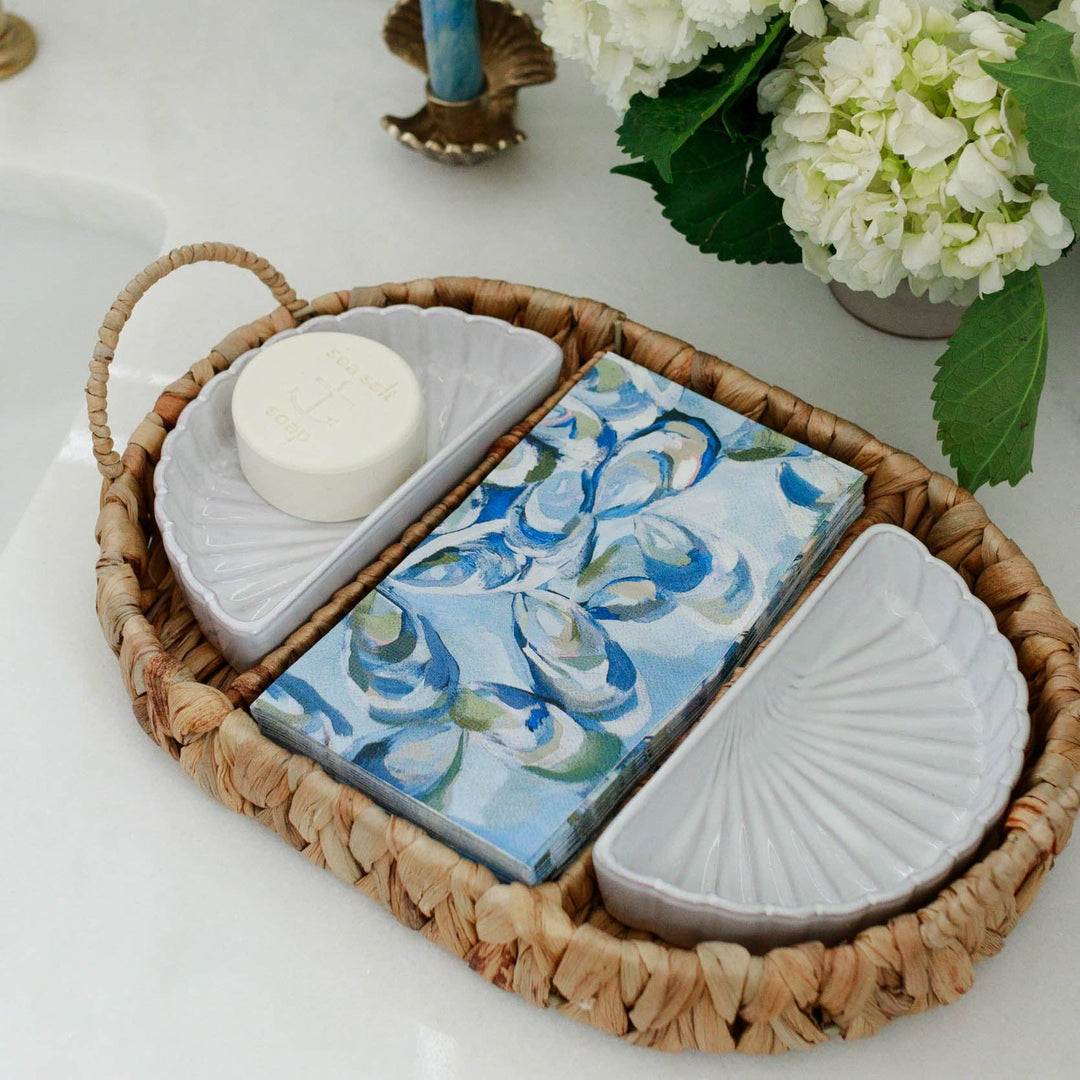 Decorative tray with atlantic reef guest towels and soap on a white surface.