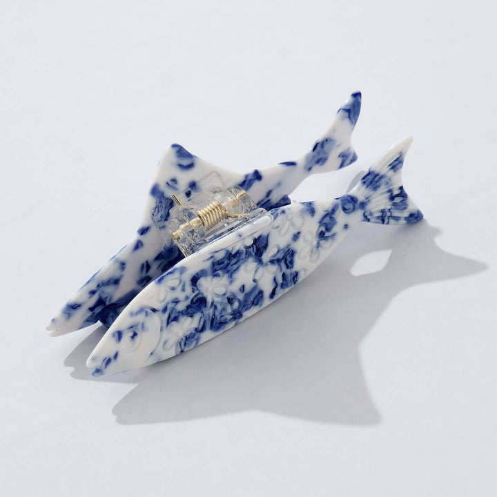 Blue and white hair clips on a light gray background