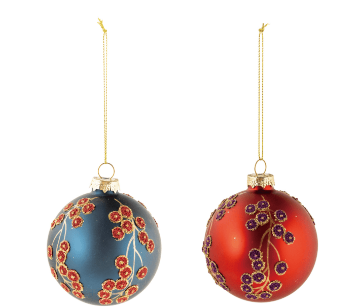 Two decorative hanging Christmas ornaments on a plain white background. One ornament is dark blue with red and gold floral motifs, and the other is red with purple and gold floral motifs.