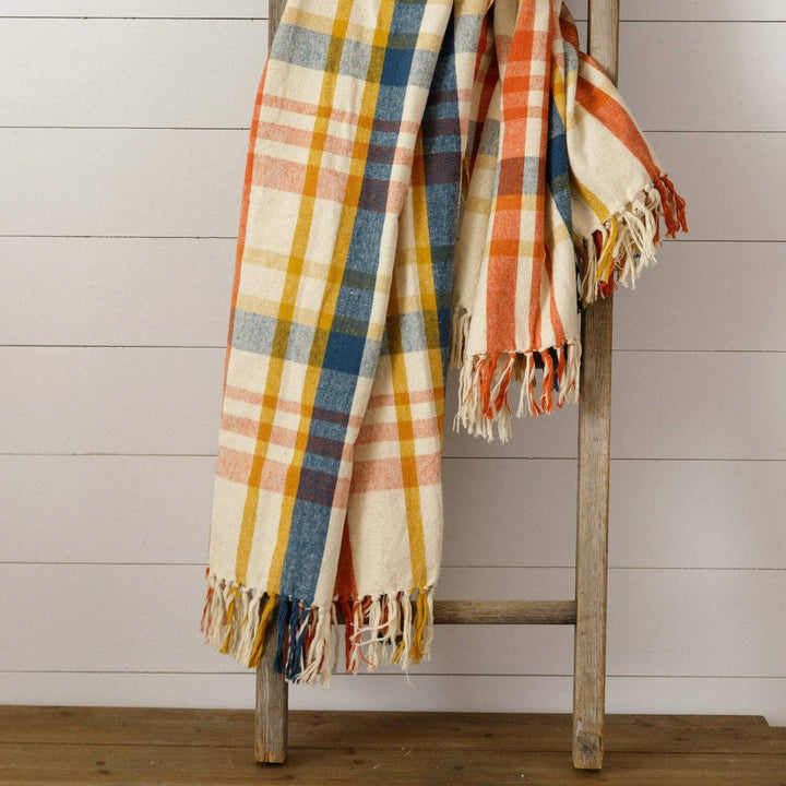 Brushed Cotton Flannel Throw in Navy, Rust, and Mustard plaid pattern on a wooden ladder with shiplap background