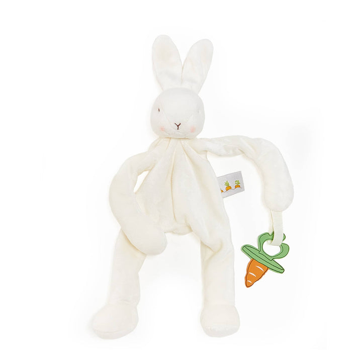 A white plush bunny lovey comforter toy with long arms and legs, featuring a small green and orange carrot teether attached to one arm, set against a plain white background.