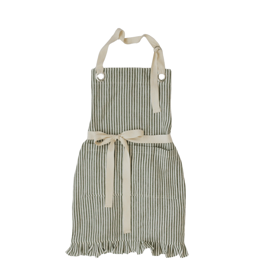 A striped kitchen apron with cream-colored neck and waist ties, featuring vertical dark green and off-white stripes, a front pocket, and a ruffled hem, shown against a solid green background.