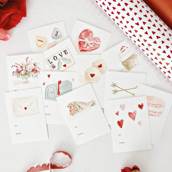 Set of Valentine's Day-themed cards with red hearts and floral designs on a white surface.