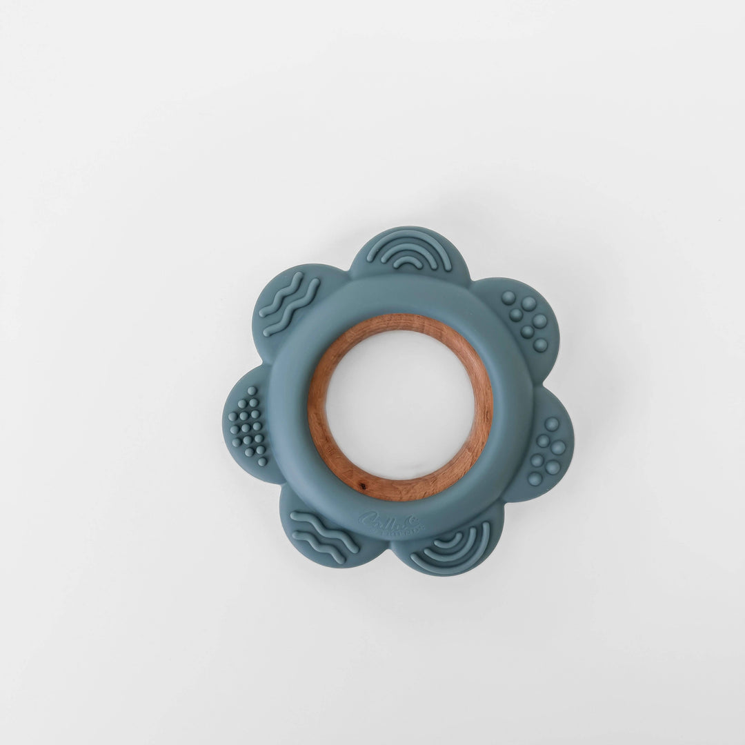Teething ring with blue silicone and wooden center on a white background