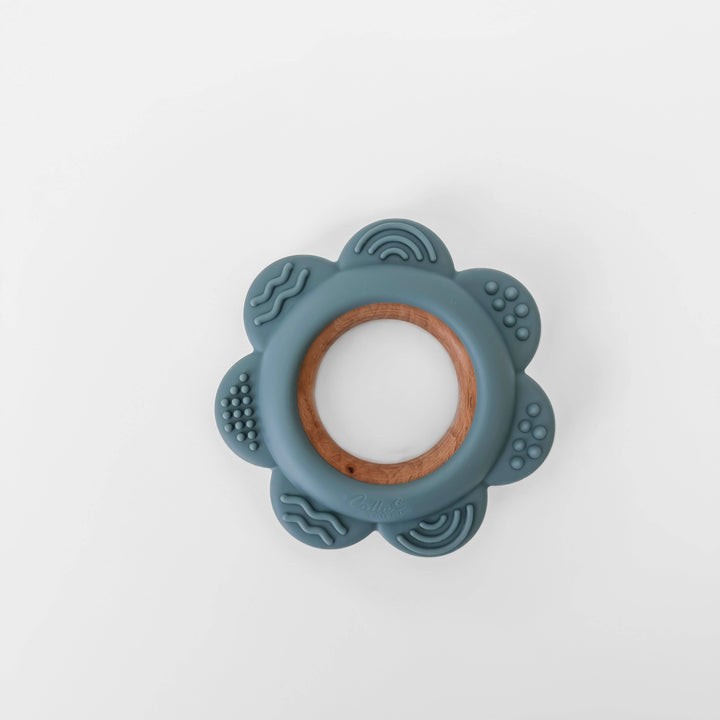 Teething ring with blue silicone and wooden center on a white background