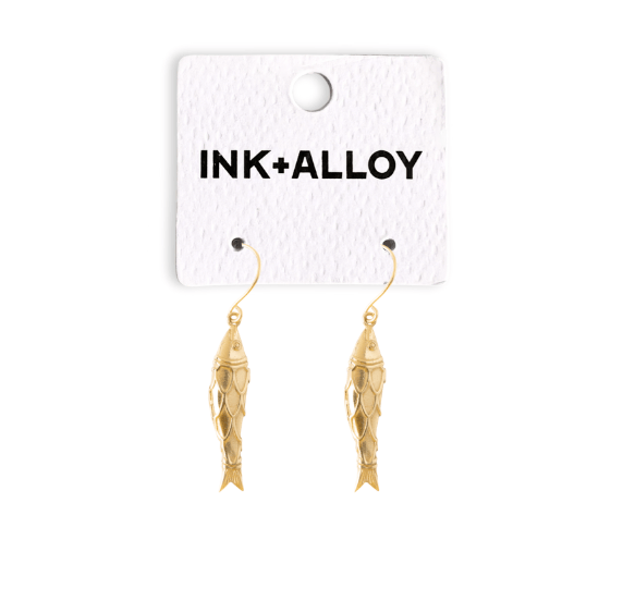 Gold fish-shaped earrings on a 'INK+ALLOY' branded card against a white background