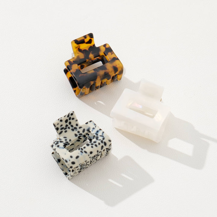 Two hair clips with tortoiseshell and dalmatian print on a white background