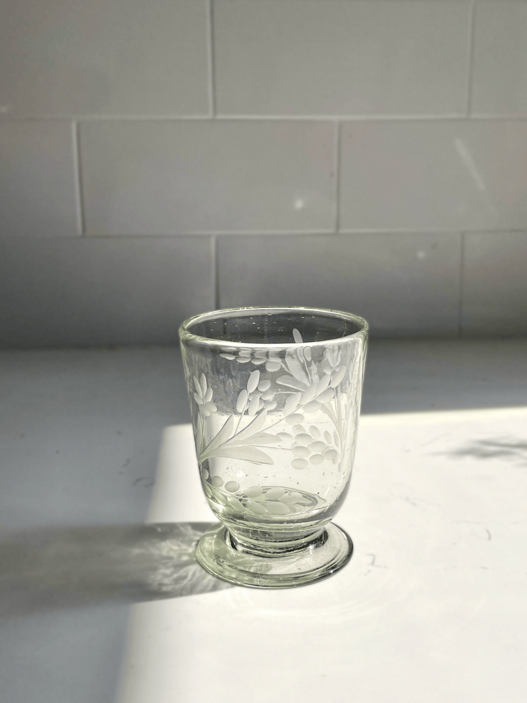 etched drinking glass on white background.