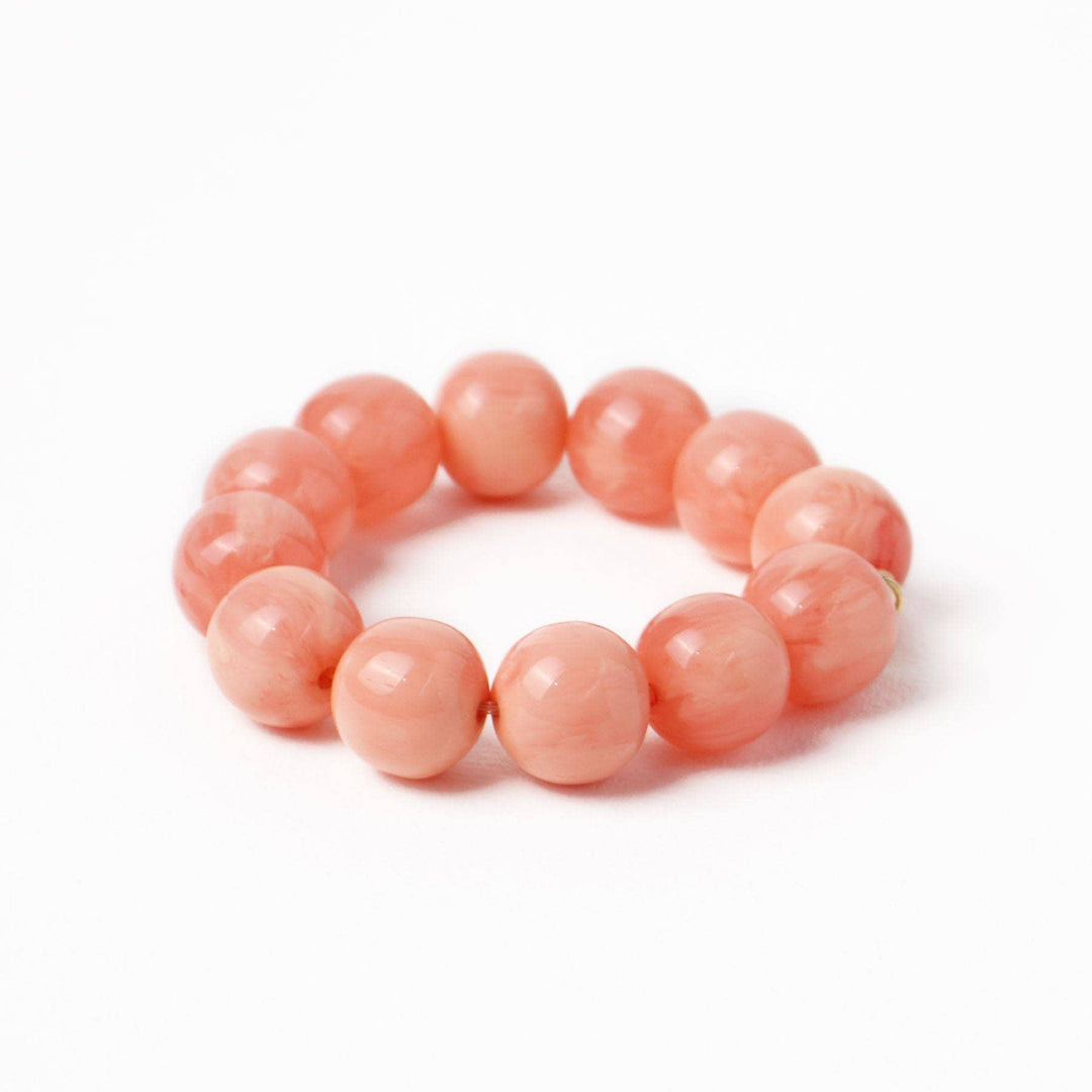 Pink beaded bracelet on a white background