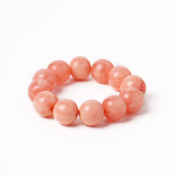 Pink beaded bracelet on a white background
