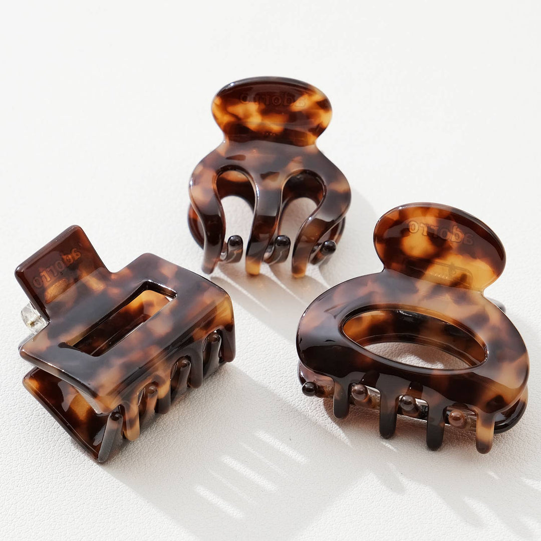 Three tortoiseshell hair clamps on a white background