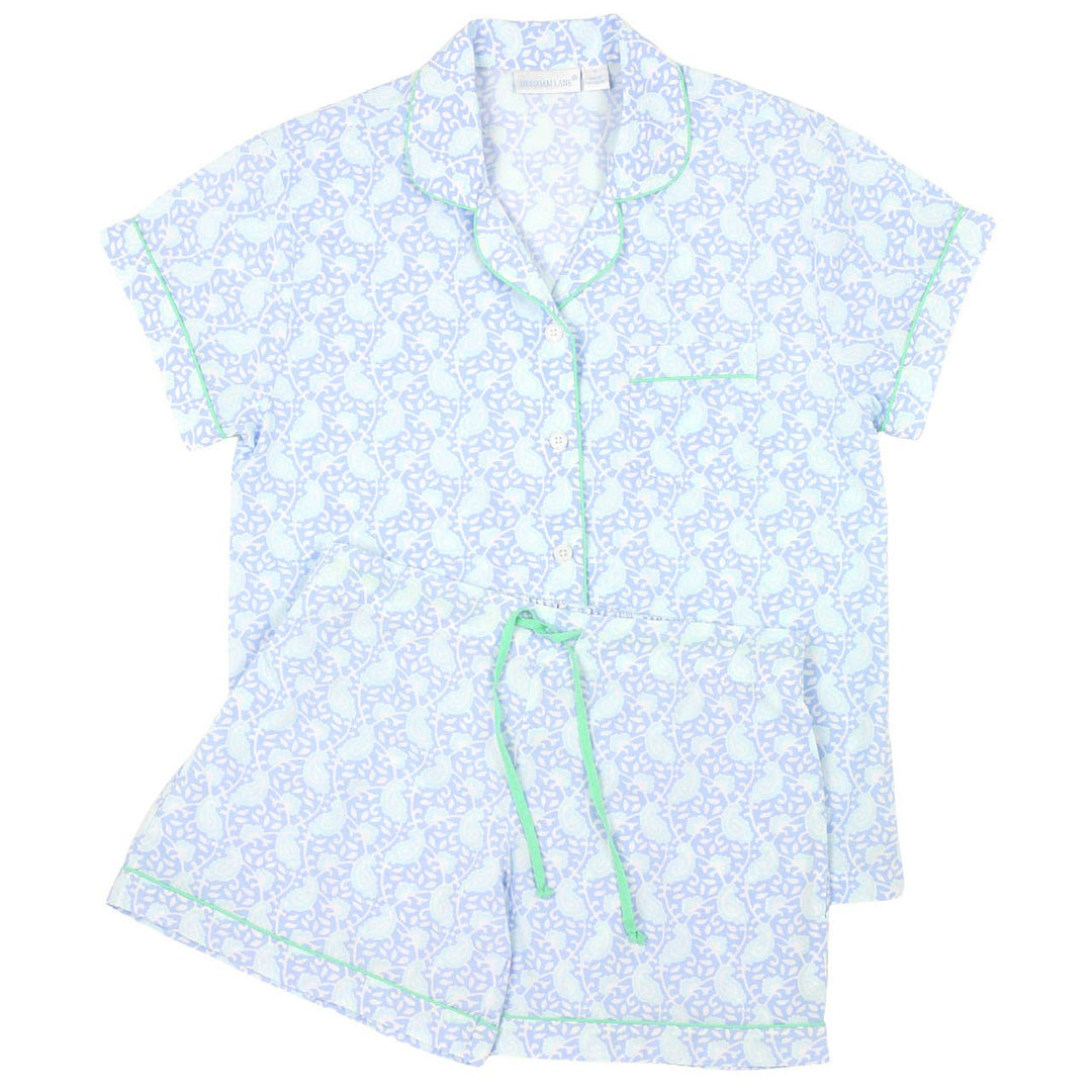 Light blue floral patterned shirt with green trim on a white background