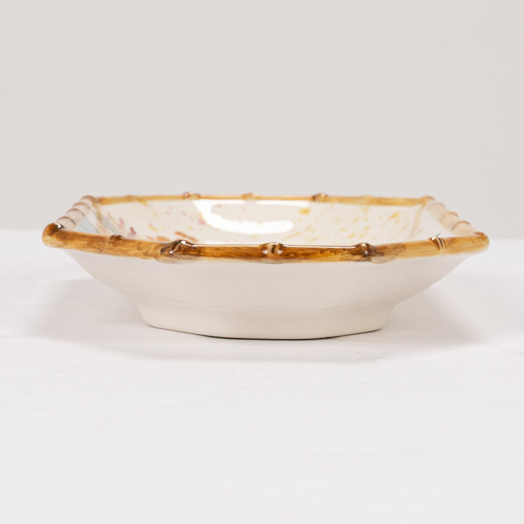 Decorative bowl with gold rim on a white background