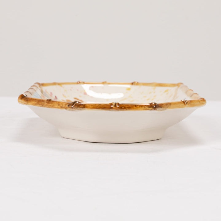 Decorative bowl with gold rim on a white background