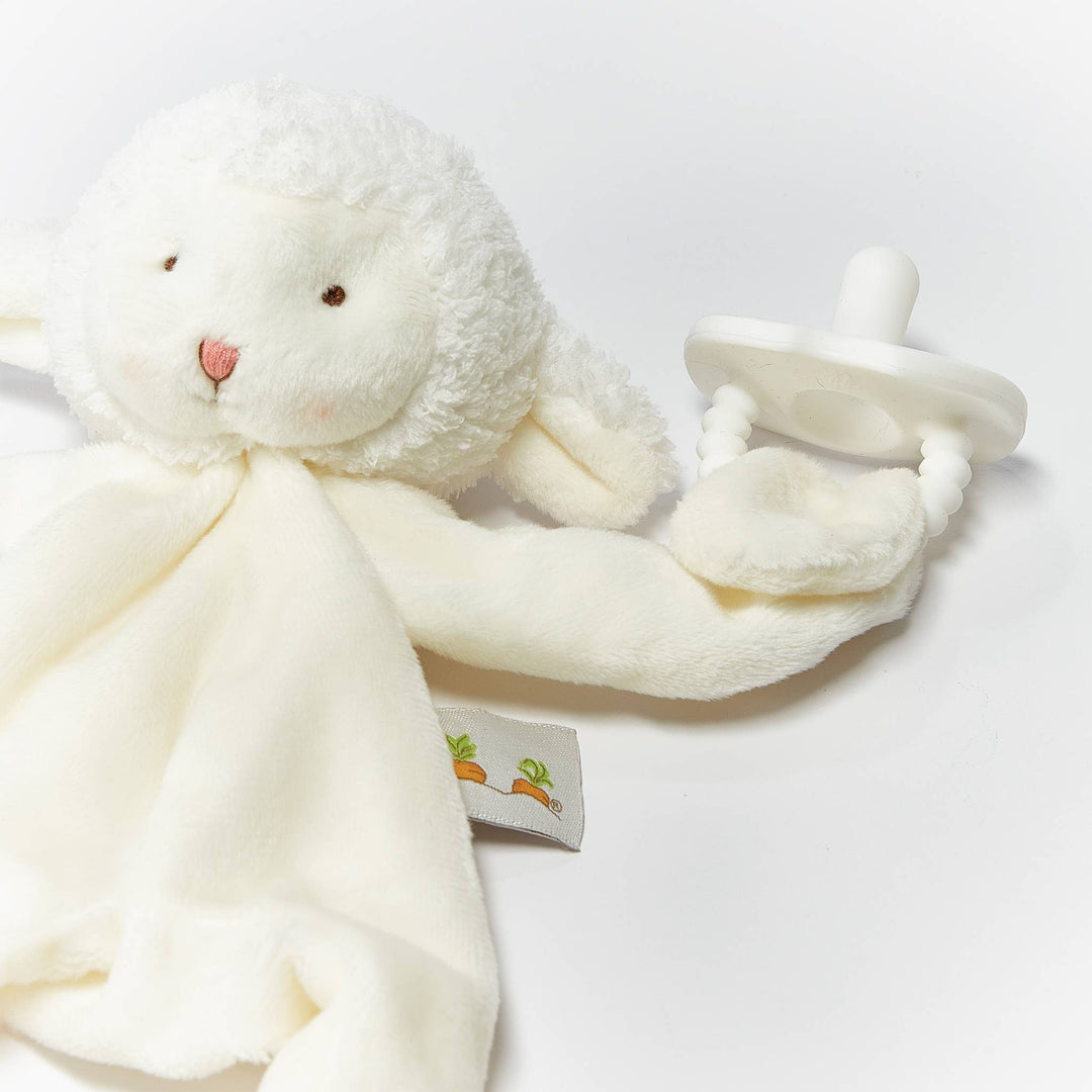 White plush bunny with a pacifier and blanket on a light gray background